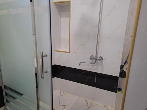 a bathroom with a shower with marble walls at Ganja VIP Home in Ganja