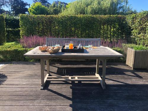 a picnic table with a tray of food on it at B&B Maison Blanche in Ghent