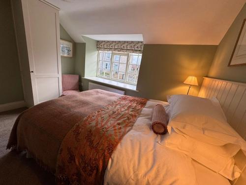 a bedroom with a large bed and a window at Woodward Farm House in Appleton le Moors