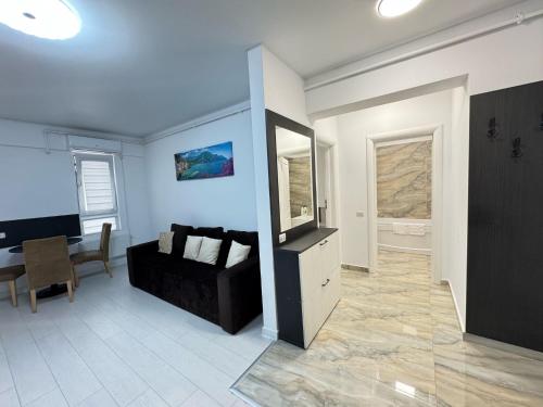 a living room with a couch and a table at Bucharest Premium Luxury Studios & Apartments by Glam Story in Bucharest