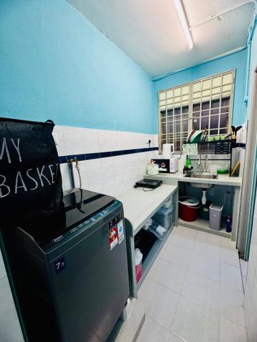 a small kitchen with a refrigerator and a counter at Affordable 2BR Homestay Malaysian guest only NearUSM Close toEverything in Gelugor