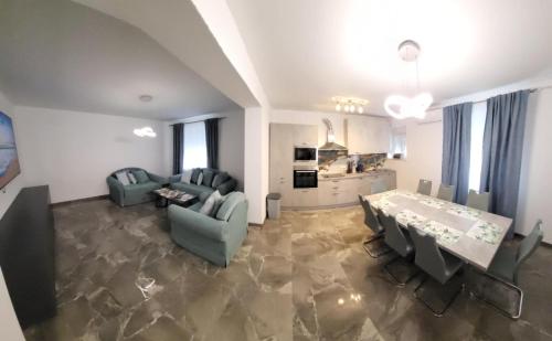 a living room with a table and chairs and a kitchen at Villa Maria in Vodice