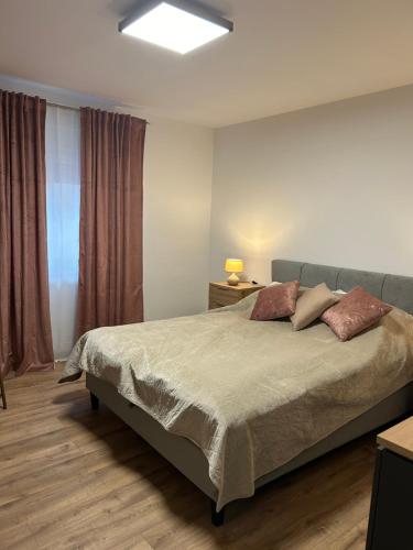 a bedroom with a large bed and a window at Villa Maria in Vodice