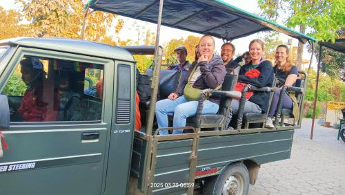 a group of people riding in the back of a vehicle at Hotel Butterfly - Peaceful Garden for Nature Lovers in Sauraha