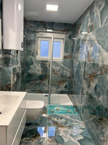 a bathroom with a shower and a sink and a toilet at Villa Maria in Vodice