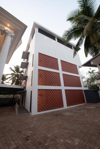 a house with a red and white garage door at Shoolin Palace in Mangalore