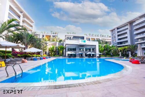 a large swimming pool in front of a building at The Expert in Ocean Blue Near Airport in Cairo