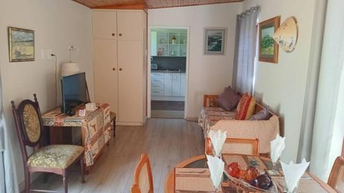a living room with two couches and a table at Armadale Country Retreat in Gqeberha
