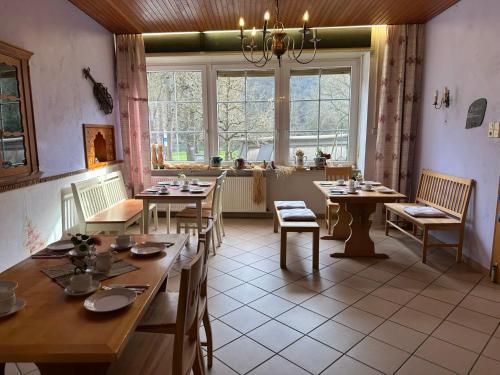 a dining room with tables and chairs and a window at Ferienhaus Löwenherz in Pommern