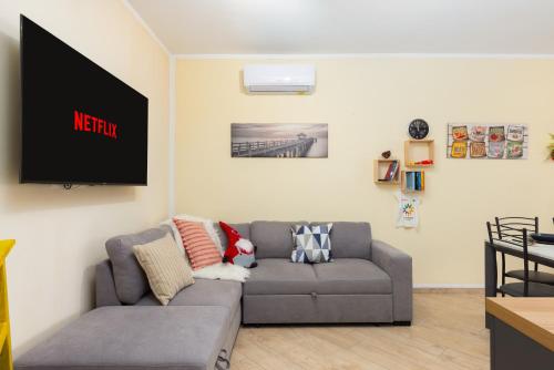 a living room with a couch and a tv at 1min from Bernina Express - Mountain View - AC - WiFi in Tirano