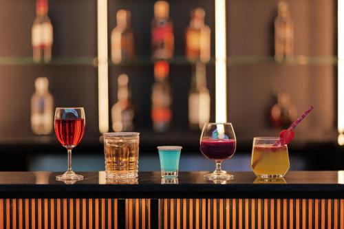 a group of four different types of drinks on a bar at Shoolin Palace in Mangalore