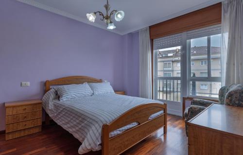a bedroom with a bed and a large window at Vivienda Alló in Rois