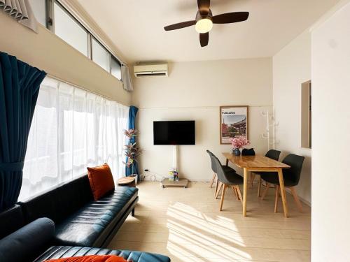 a living room with a couch and a table at Easy go to Hakata and Tenjin, Close to FKK Airport in Itazuke