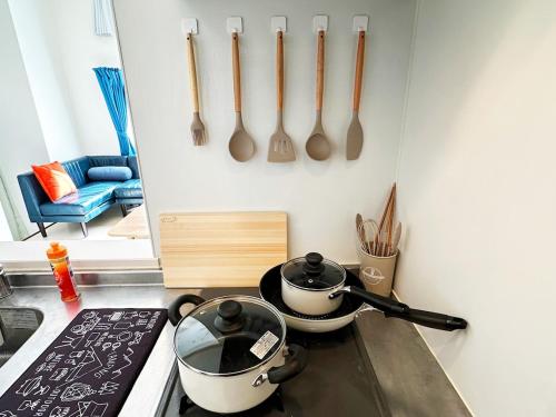 a kitchen with two pots and pans on a stove at Easy go to Hakata and Tenjin, Close to FKK Airport in Itazuke
