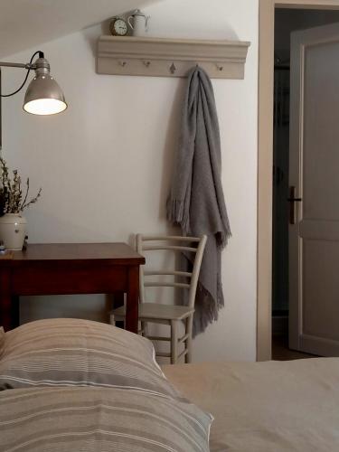 a bedroom with a desk and a chair and a bed at Lo noú b&b in Aosta