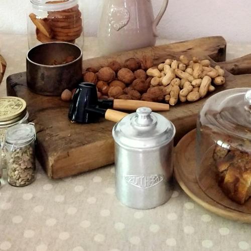 a table with a cutting board with nuts on it at Lo noú b&b in Aosta