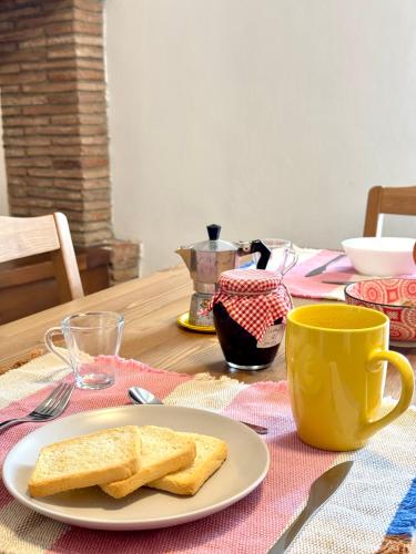 a plate with two slices of bread on a table at Appartamento in pieno centro - La Piazzetta in Passignano sul Trasimeno