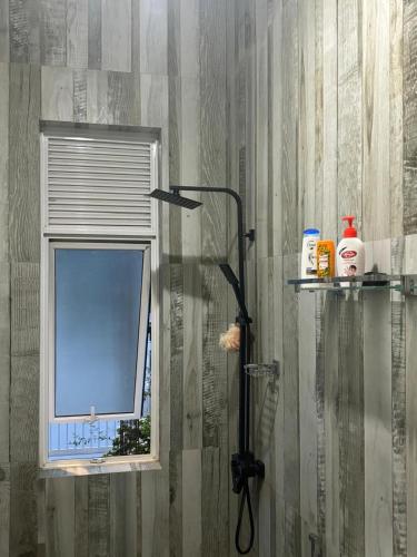 a shower with a window in a bathroom at Genuine Resort Kandy in Kandy