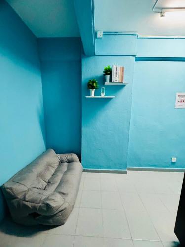 a blue room with a dog bed in the corner at 3br 8 pax budget Malaysian guest only family stay in penang in Gelugor