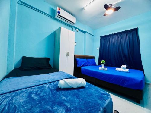 two beds in a room with blue walls at 3br 8 pax budget Malaysian guest only family stay in penang in Gelugor