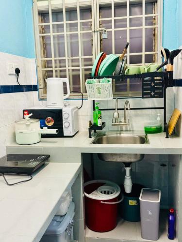 a kitchen with a sink and a counter top at 3br 8 pax budget Malaysian guest only family stay in penang in Gelugor