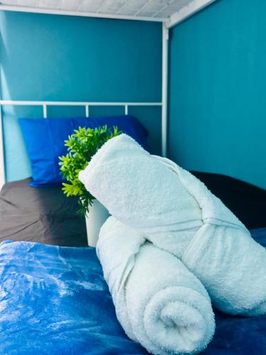 a pile of white towels sitting on top of a bed at 3br 8 pax budget Malaysian guest only family stay in penang in Gelugor