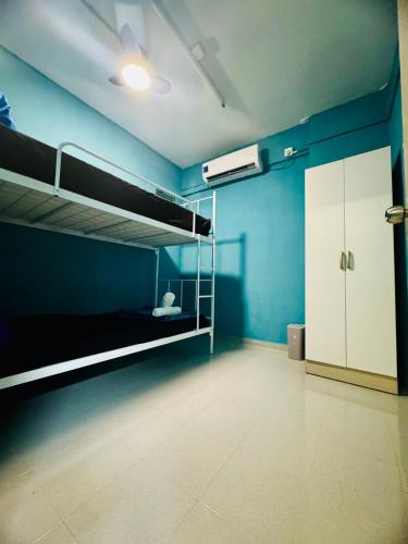 a room with two bunk beds and a blue wall at 3br 8 pax budget Malaysian guest only family stay in penang in Gelugor