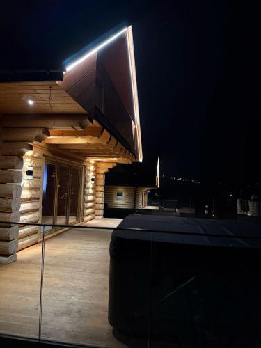 a building with a tv on top of it at night at Skalna Osada in Istebna
