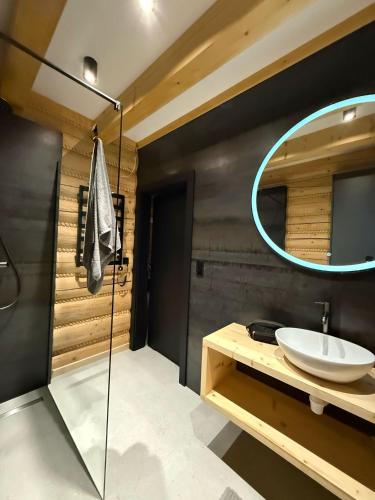 a bathroom with a sink and a mirror at Skalna Osada in Istebna