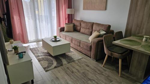 a living room with a couch and a table at Silver Dream 1 in Veliko Gradište