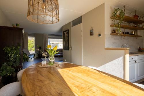 a kitchen with a wooden table in a room at Large waterfront family home! in Workum