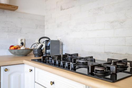 a kitchen counter with a black stove top oven at Large waterfront family home! in Workum