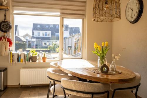 a dining room table with chairs and a large window at Large waterfront family home! in Workum
