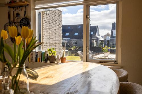 a table in a kitchen with a large window at Large waterfront family home! in Workum