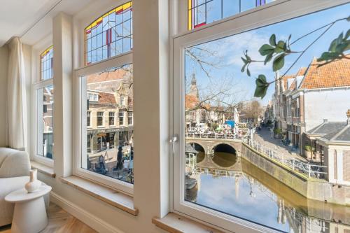 a window with a view of a canal at STONEBRIDGE boutique apartments - City centre in Alkmaar