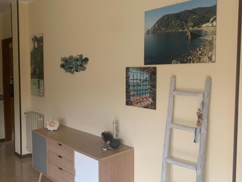 a room with a desk and a ladder on a wall at Little Home in Pignone