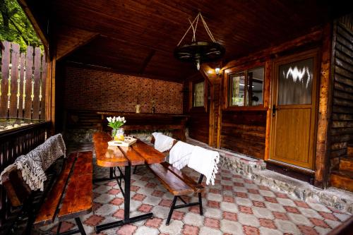 a wooden room with a wooden table and chairs at Wooden House Torocko-Rimetea in Rimetea
