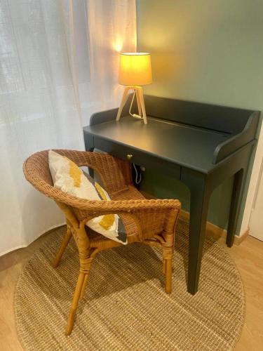 a green piano with a chair and a lamp at Serene 1BR Oasis in the Heart of Sens Center in Sens