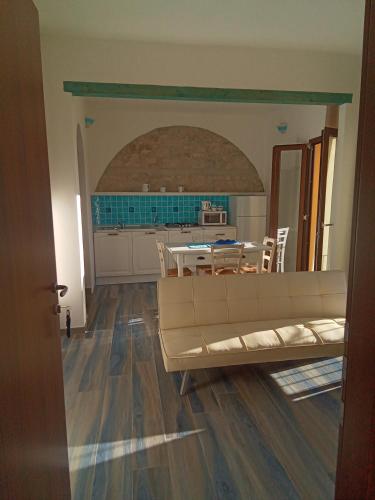 a living room with a couch and a table at Sa Dommu de Kerciu Sea view with parking in Baunei