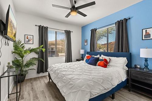 a blue bedroom with a bed and a ceiling fan at Family Fun ASU Football Stay , 2BR, Pool & Spa- 1001 in Tempe