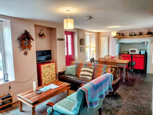 a living room with a couch and a table at Moymore Cottage in Lahinch