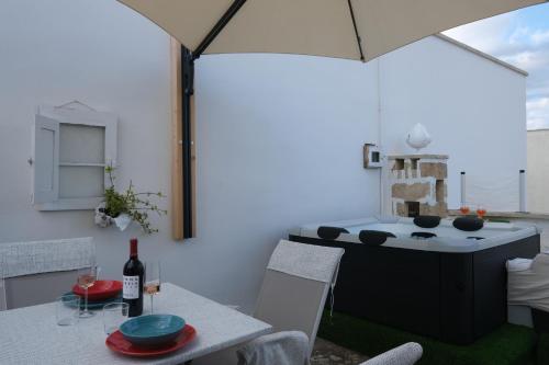 a kitchen with a table with a bottle of wine at Casina Li Fumareddhi in Corsano