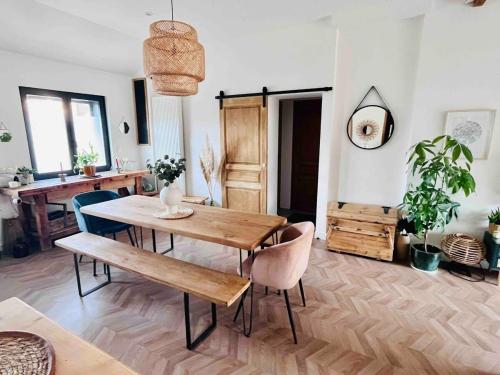 une salle à manger avec une table et des chaises en bois dans l'établissement charming single-storey house, à Saint-André