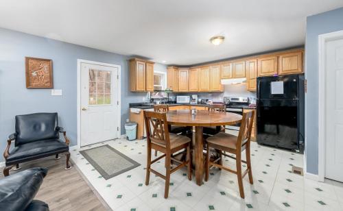 a kitchen with a wooden table and a black refrigerator at Comfortable & Healthy Home in Parkesburg