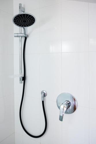 a shower with a shower head in a bathroom at Le Rose - Suites e Breakfast a 5 min dal mare e Misano World Circuit in Misano Adriatico