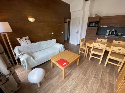 un salon avec un canapé et une table dans l'établissement Charmant T3 avec piscine et balcon, proche station - FR-1-342-333, à Hauteluce