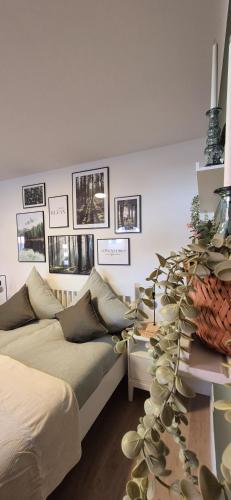 a room with two beds and a table with a plant at NEYSES Apartments - Kylltalperle in Kordel