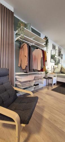 a living room with a closet with racks of clothes at NEYSES Apartments - Kylltalperle in Kordel