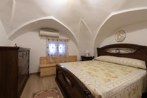 a bedroom with a bed and a dresser and a window at At Anna's house in the heart of Salento in Supersano