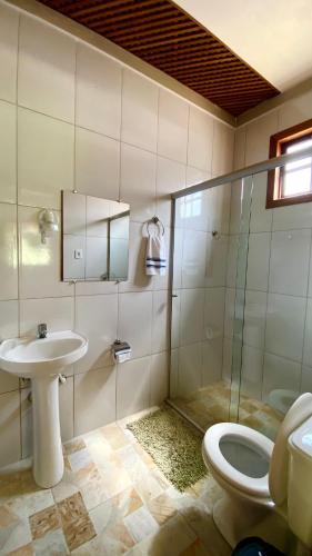 a bathroom with a toilet and a sink and a shower at Chalé Topázio in Ouro Preto